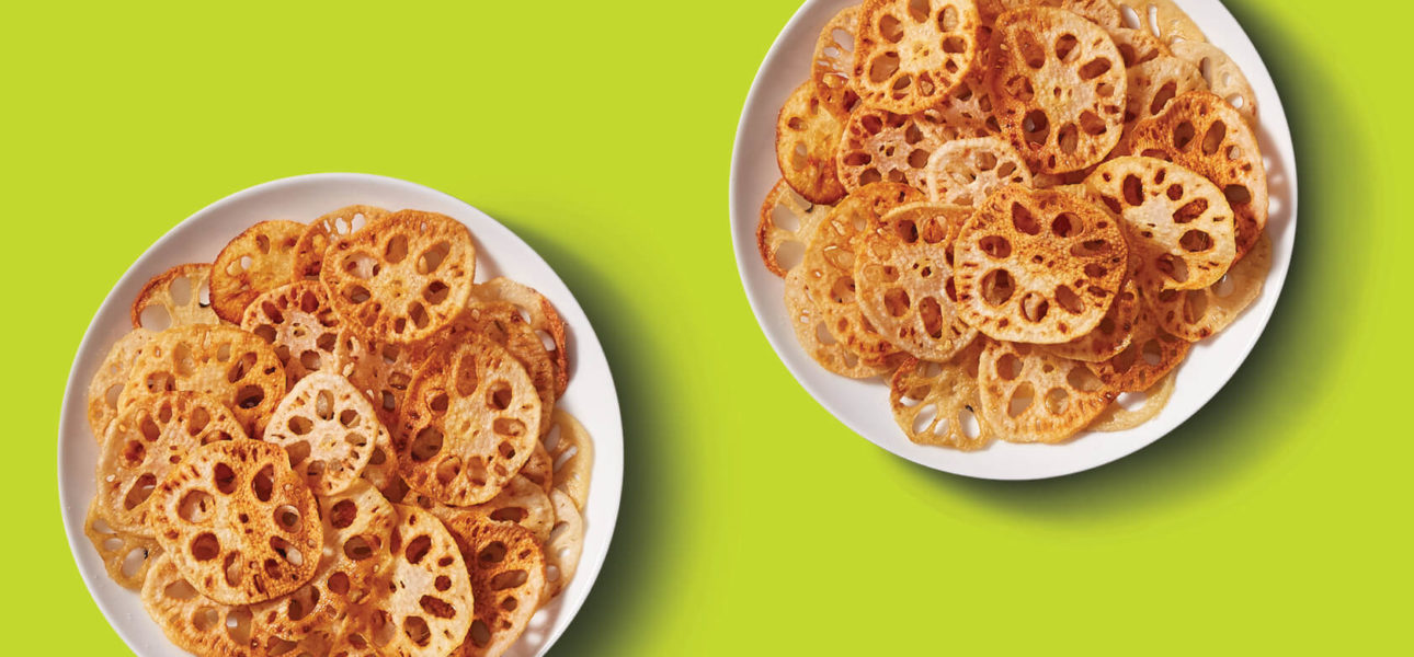 A picture of two white bowls filled with fried, crispy and crunchy Lotus root chips.