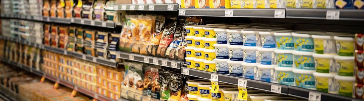 Fully stocked shelves of the dairy section in the store